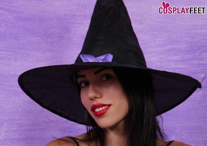 Flirty brunette Petra in a sexy witch Halloween costume